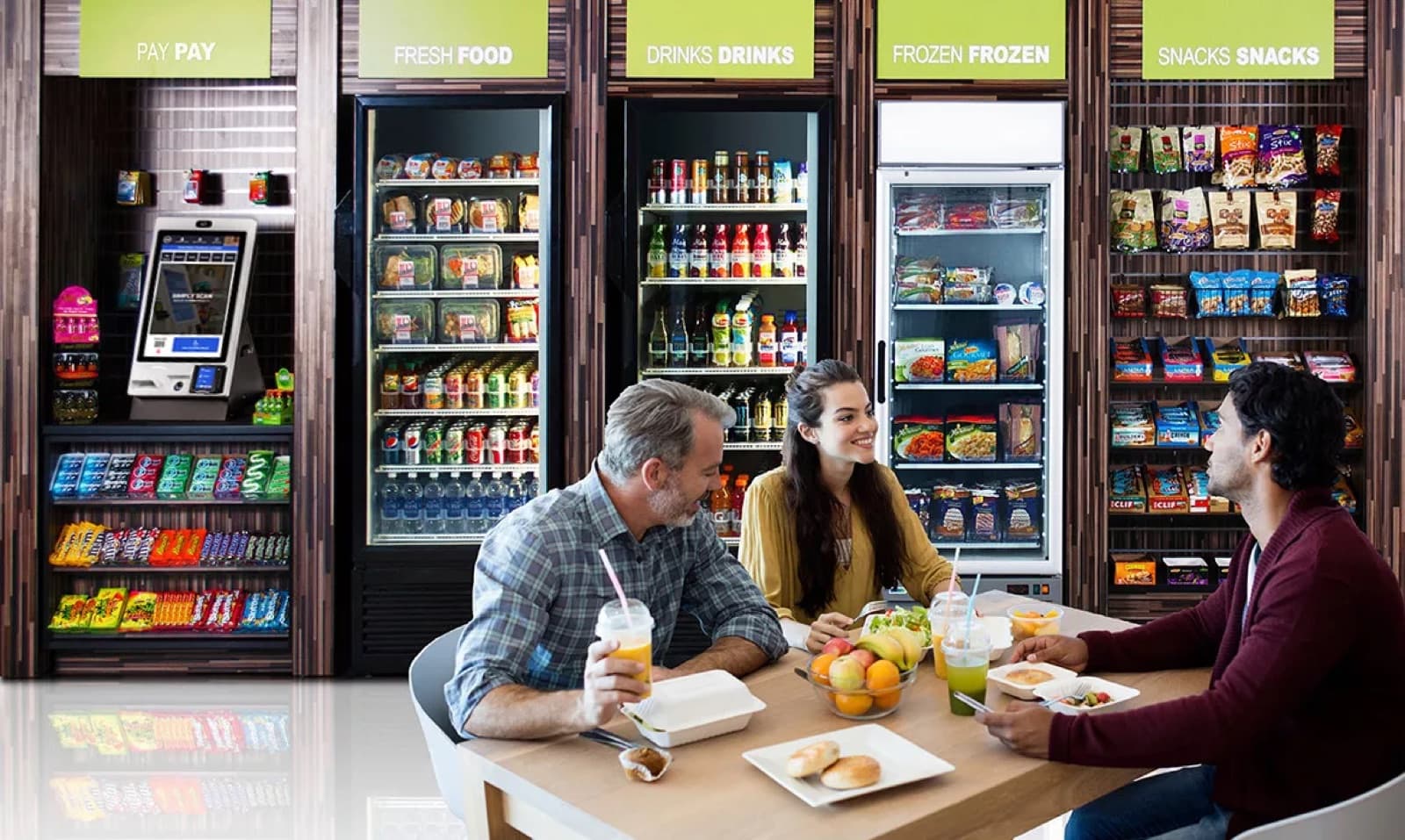 Open micro market with coolers, shelving, and a self-checkout kiosk