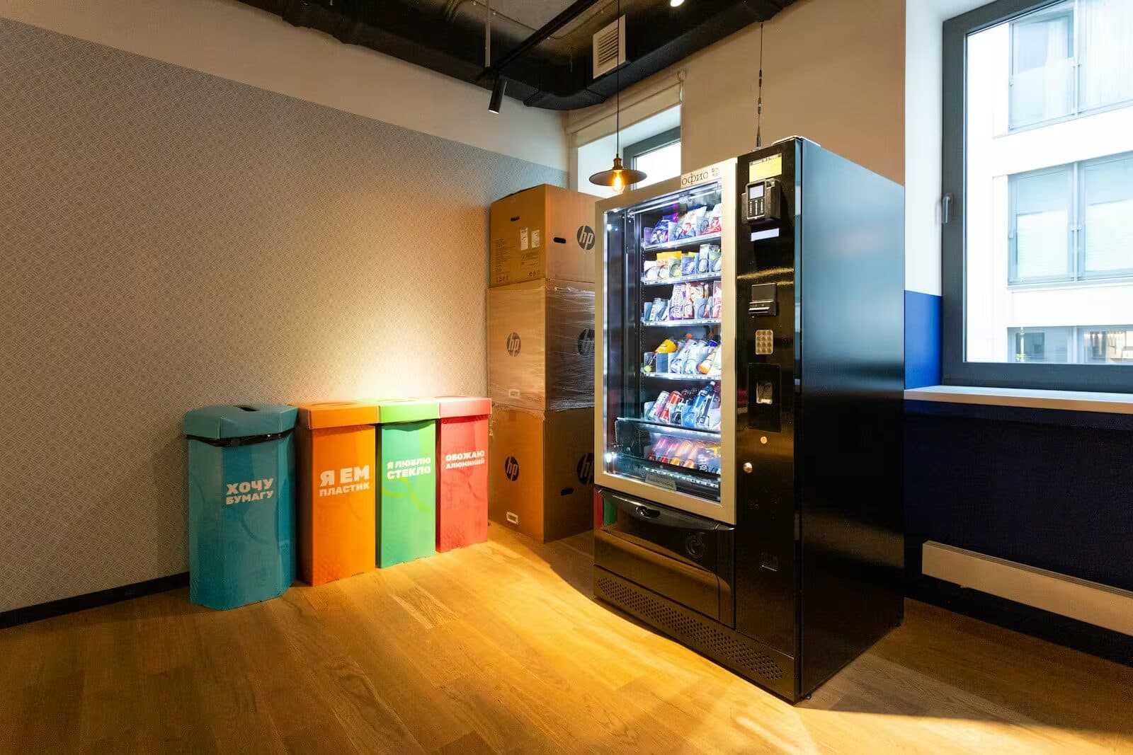 Bright office break room with seating and a grab-and-go station