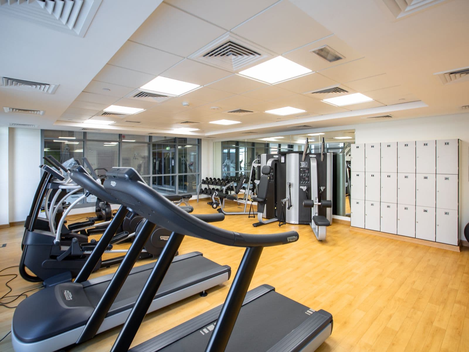 Gym interior with equipment and a refrigerated drinks cooler